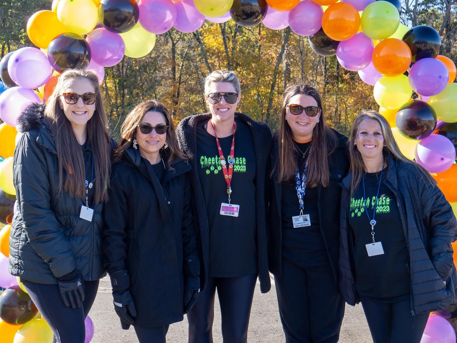 five women in black shirts